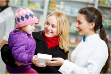 Pharmacist talking to a mother and her child